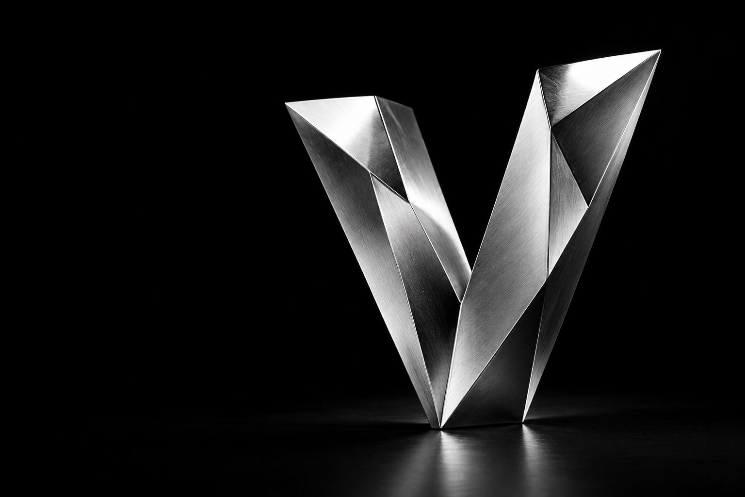 A sculptural silver V with precision-cut metallic facets